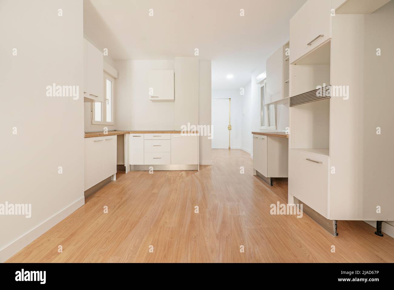 Photo of a newly installed kitchen awaiting appliances, open to a ...