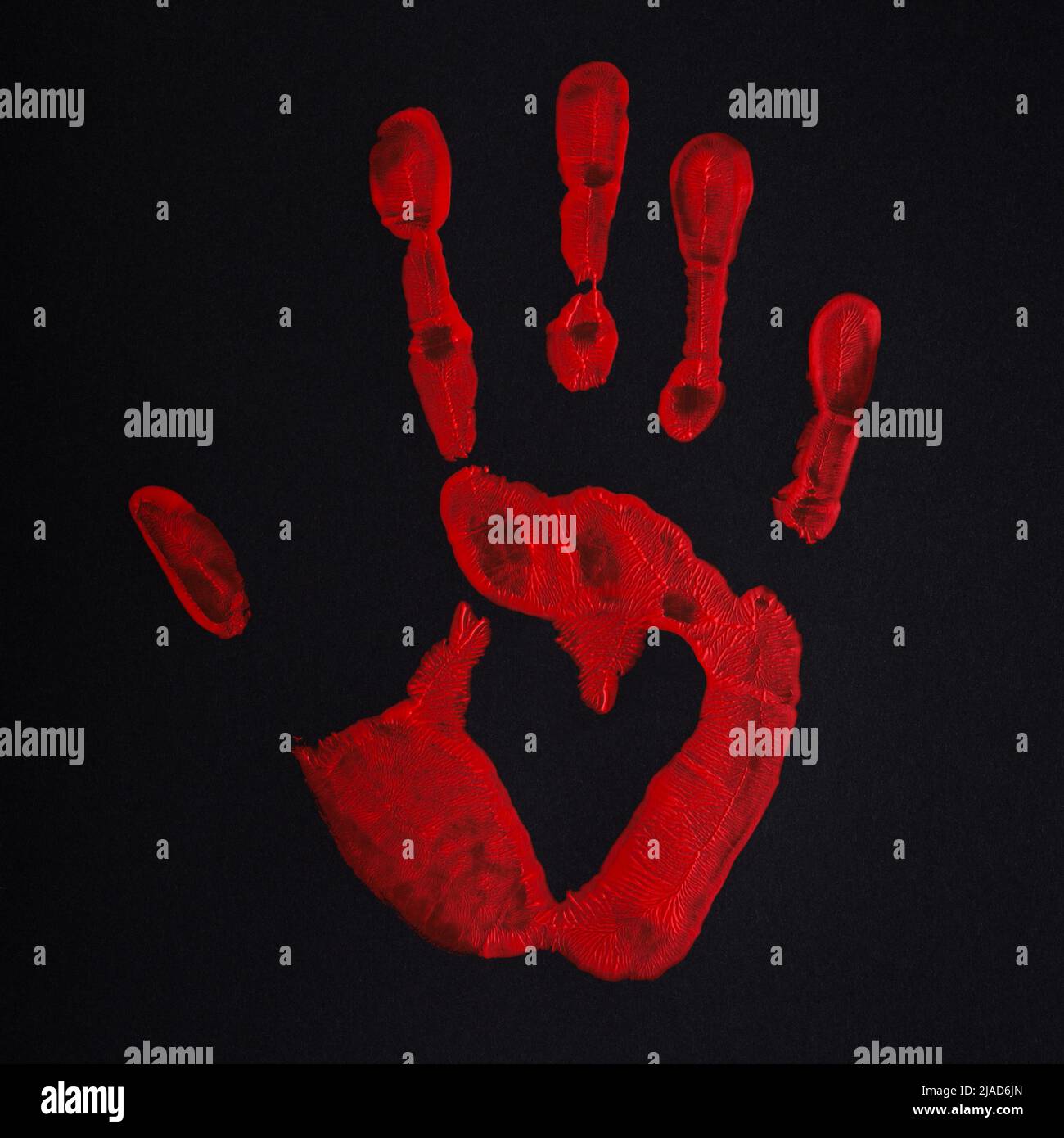 Red palm print on black background with heart, stop bloodshed and war, peace concept. Stock Photo
