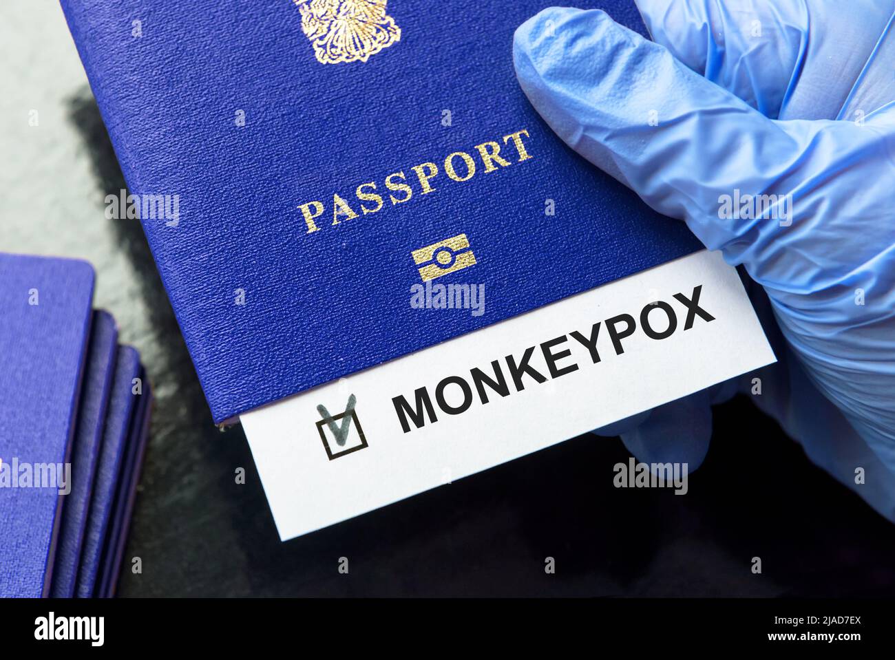 Travel and monkey pox concept, a note Monkeypox in tourist passport. Medical test at border control due to smallpox spread. Business and tourism hit b Stock Photo