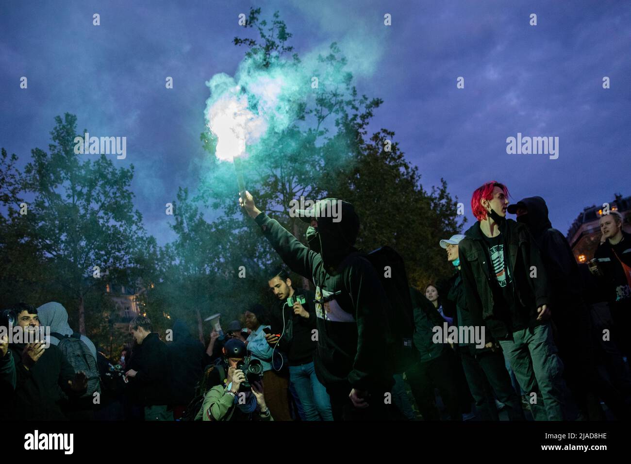 Protestor hold a bomb smoke during a protest in Paris Stock Photo