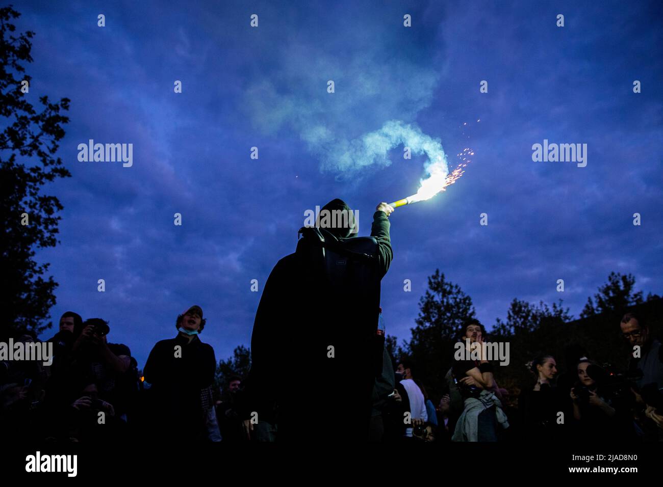 Protestor hold a bomb smoke during a protest in Paris Stock Photo