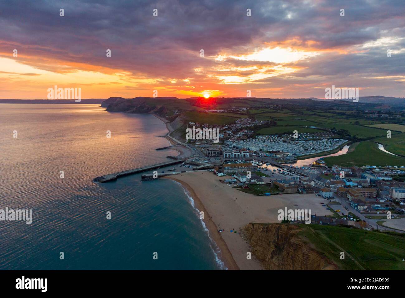 West Bay, Dorset, UK. 29th May 2022. UK Weather. Sunset at the seaside