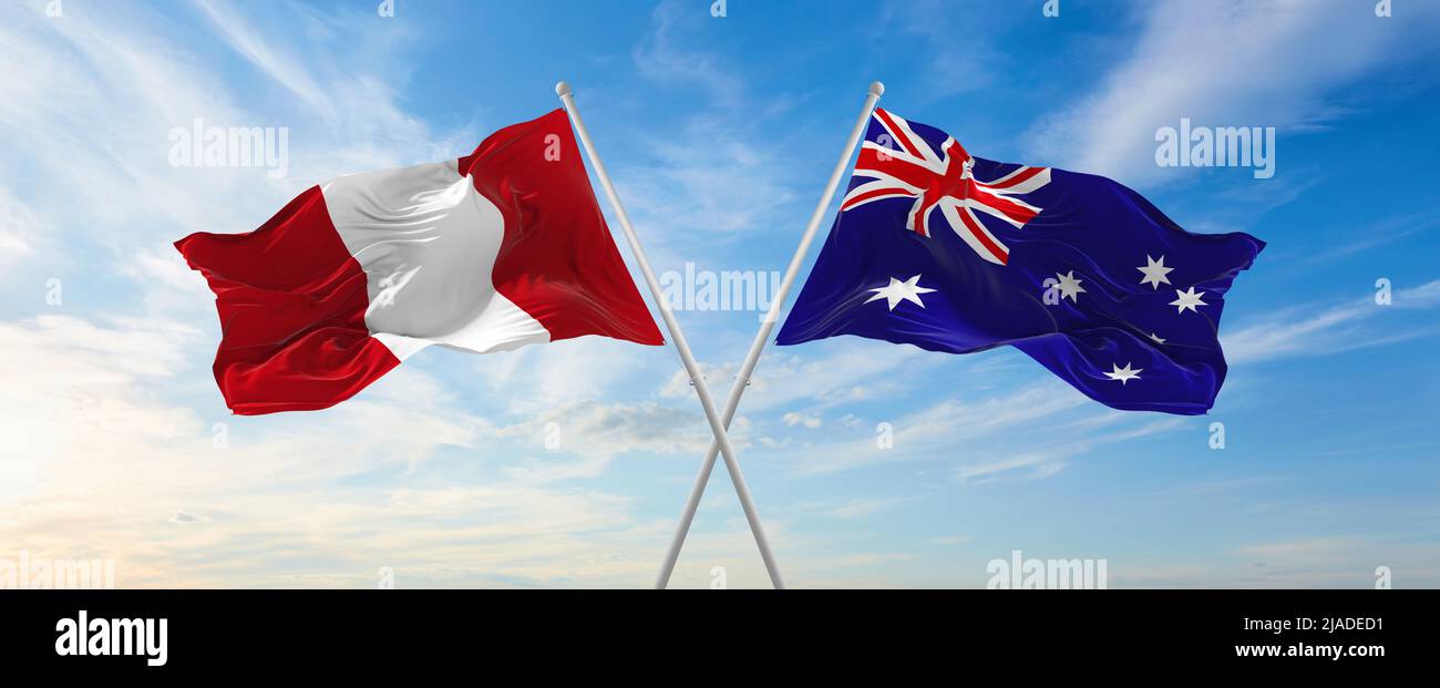 two crossed flags Peru and Australia waving in wind at cloudy sky ...