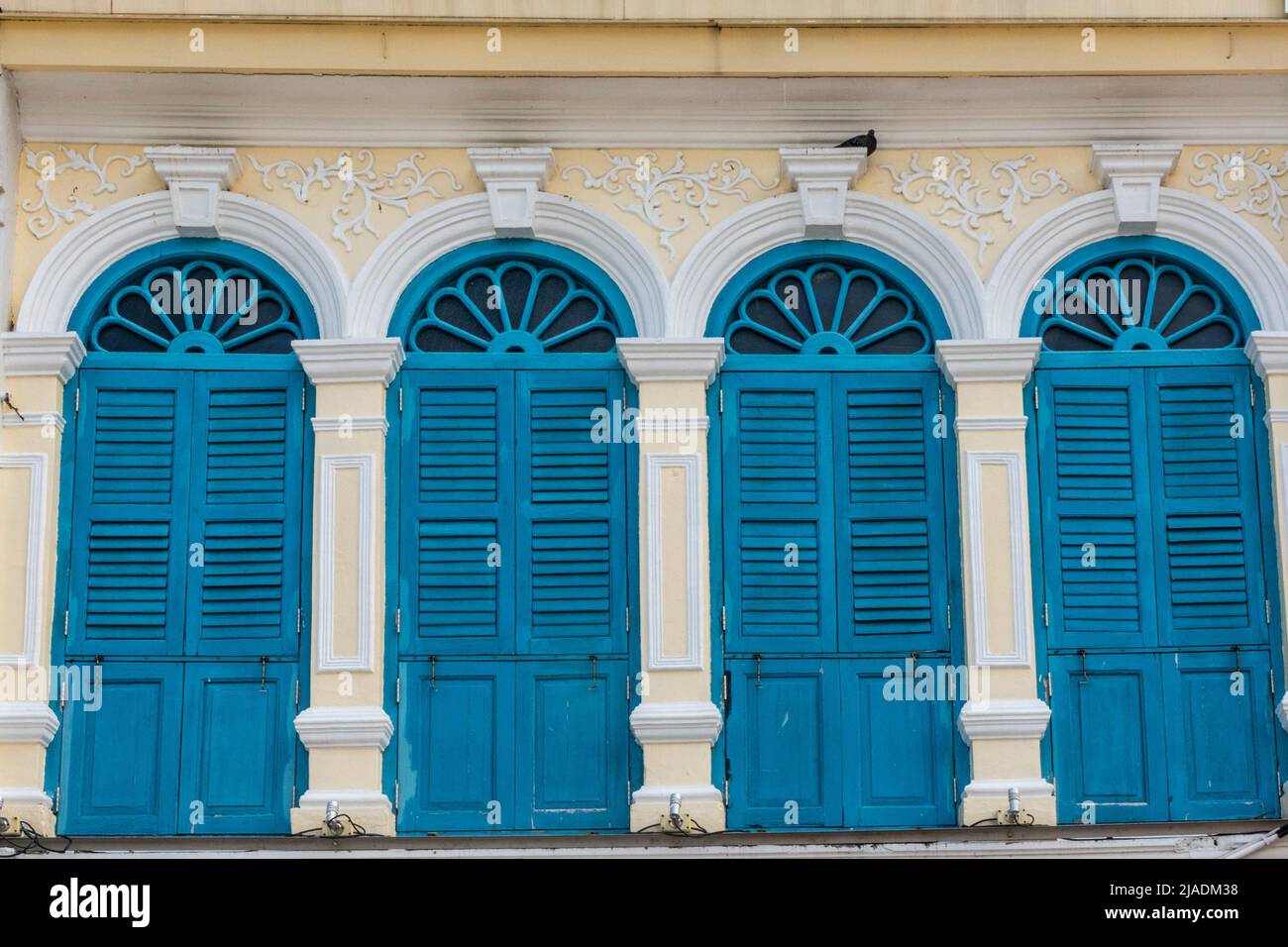 Sino Portuguese architecture windows with shutters in  Old Phuket Town, Thailand Stock Photo