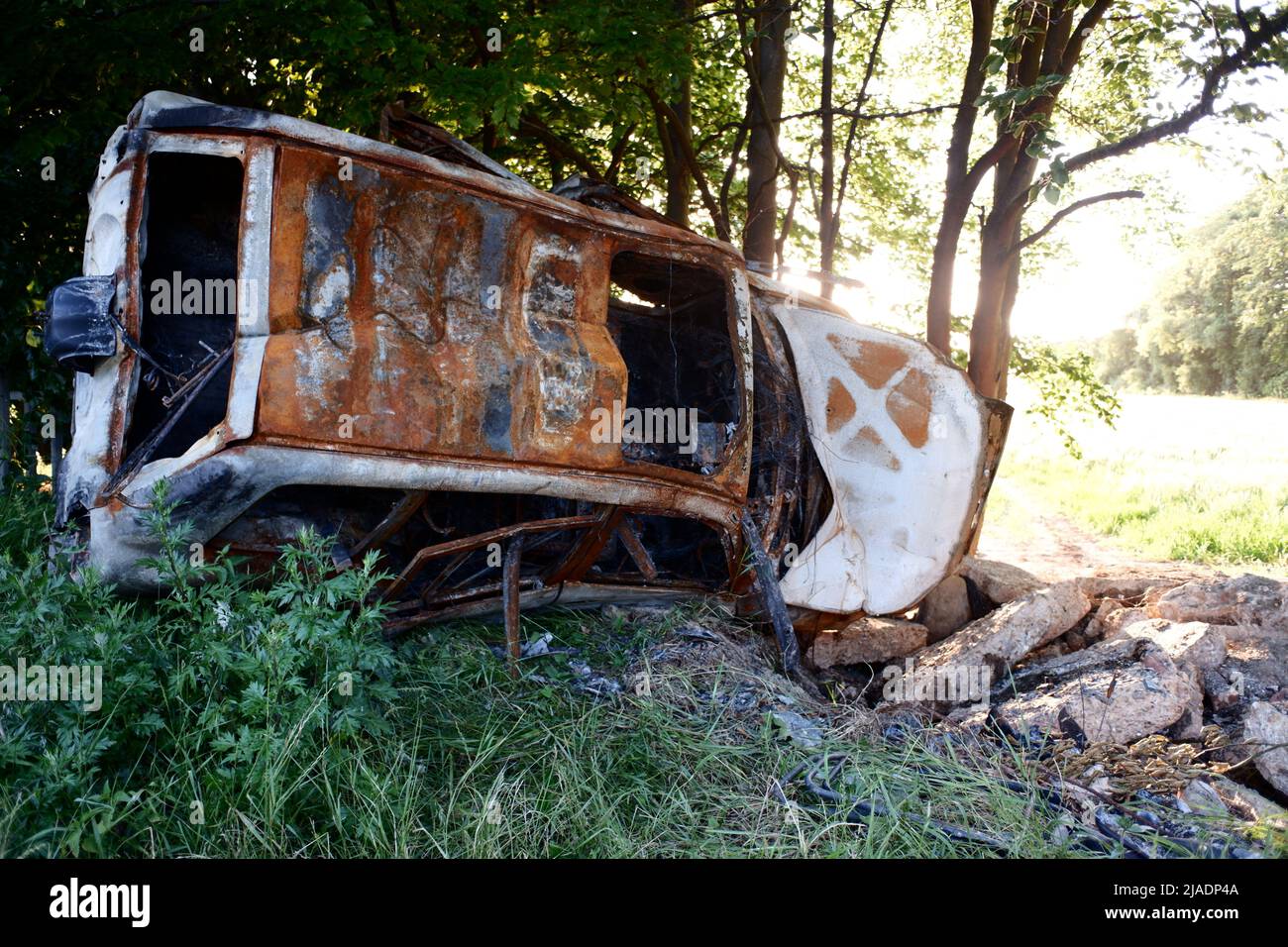 Crashed burned out abandoned car wreck in Hertfordshire England UK Stock Photo
