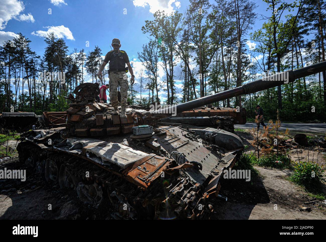 Dmytrivka, Ukraine. 29th May, 2022. A man looks at a destroyed Russian tank at Dmytrivka village near the Ukrainian capital Kyiv. Russia invaded Ukraine on 24 February 2022, triggering the largest military attack in Europe since World War II. Credit: SOPA Images Limited/Alamy Live News Stock Photo