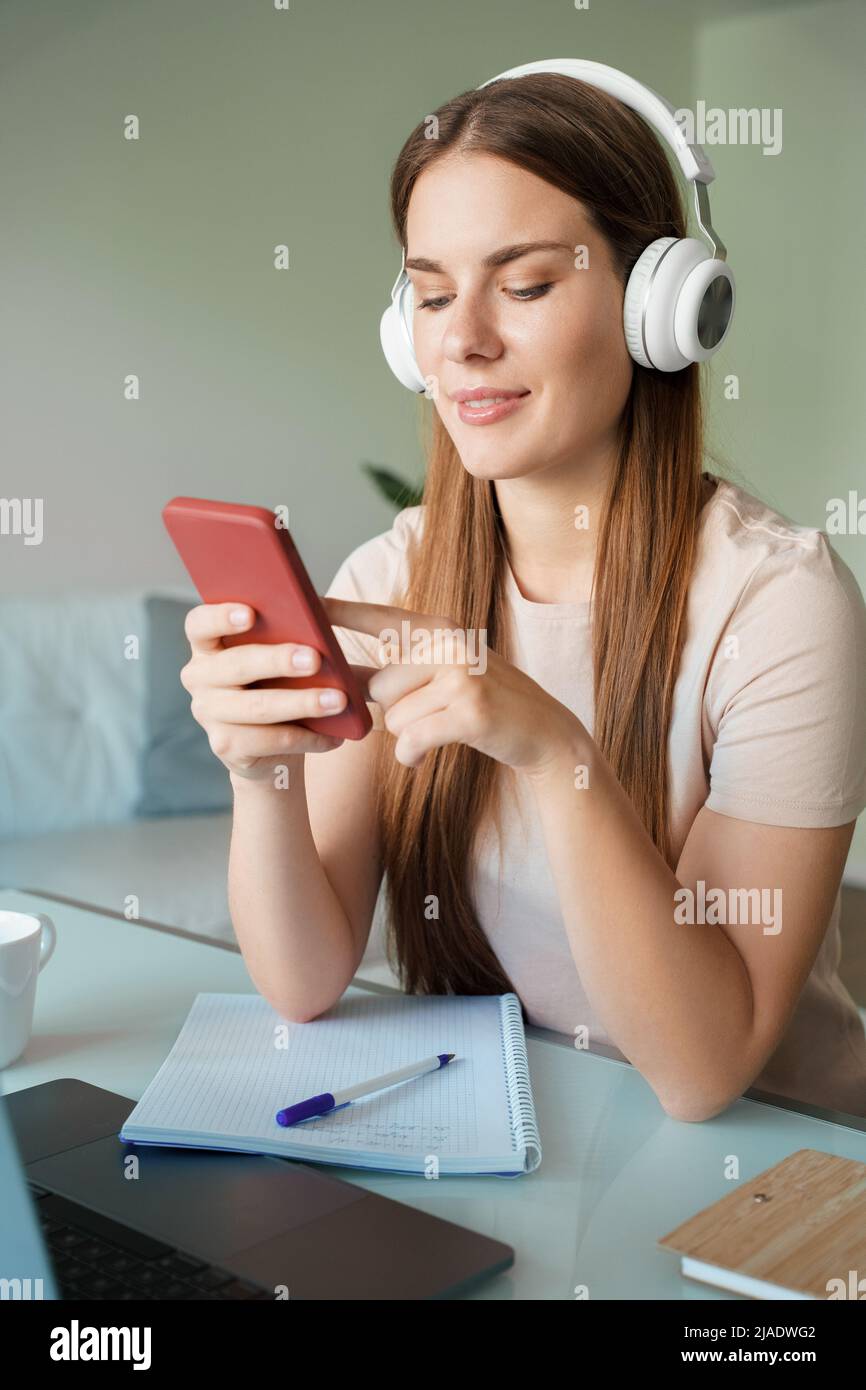 Portrait of young woman freelancer reading notification on smartphone Stock Photo