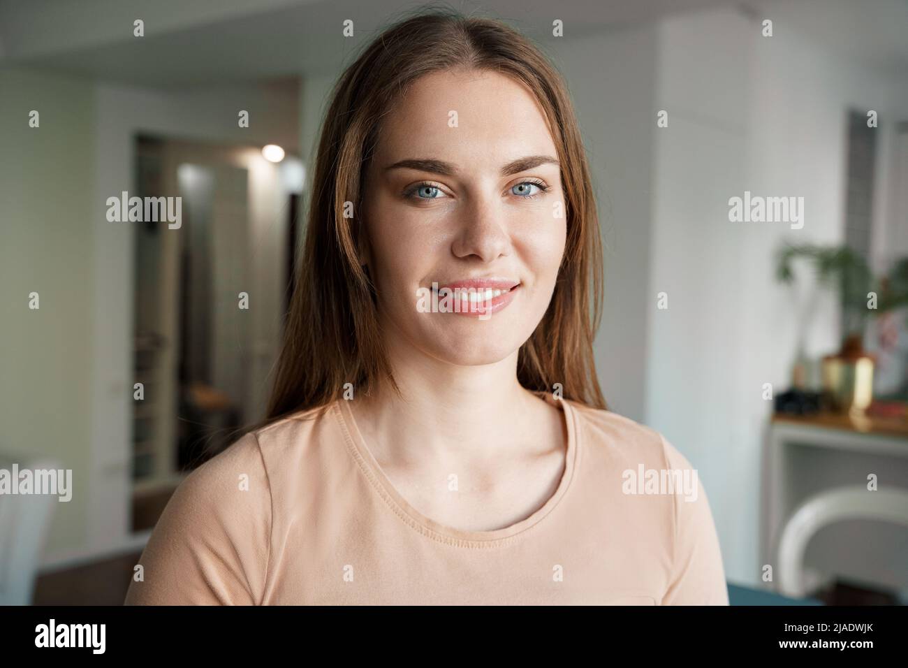 Portrait of smiling teenage woman college student looking at camera ...