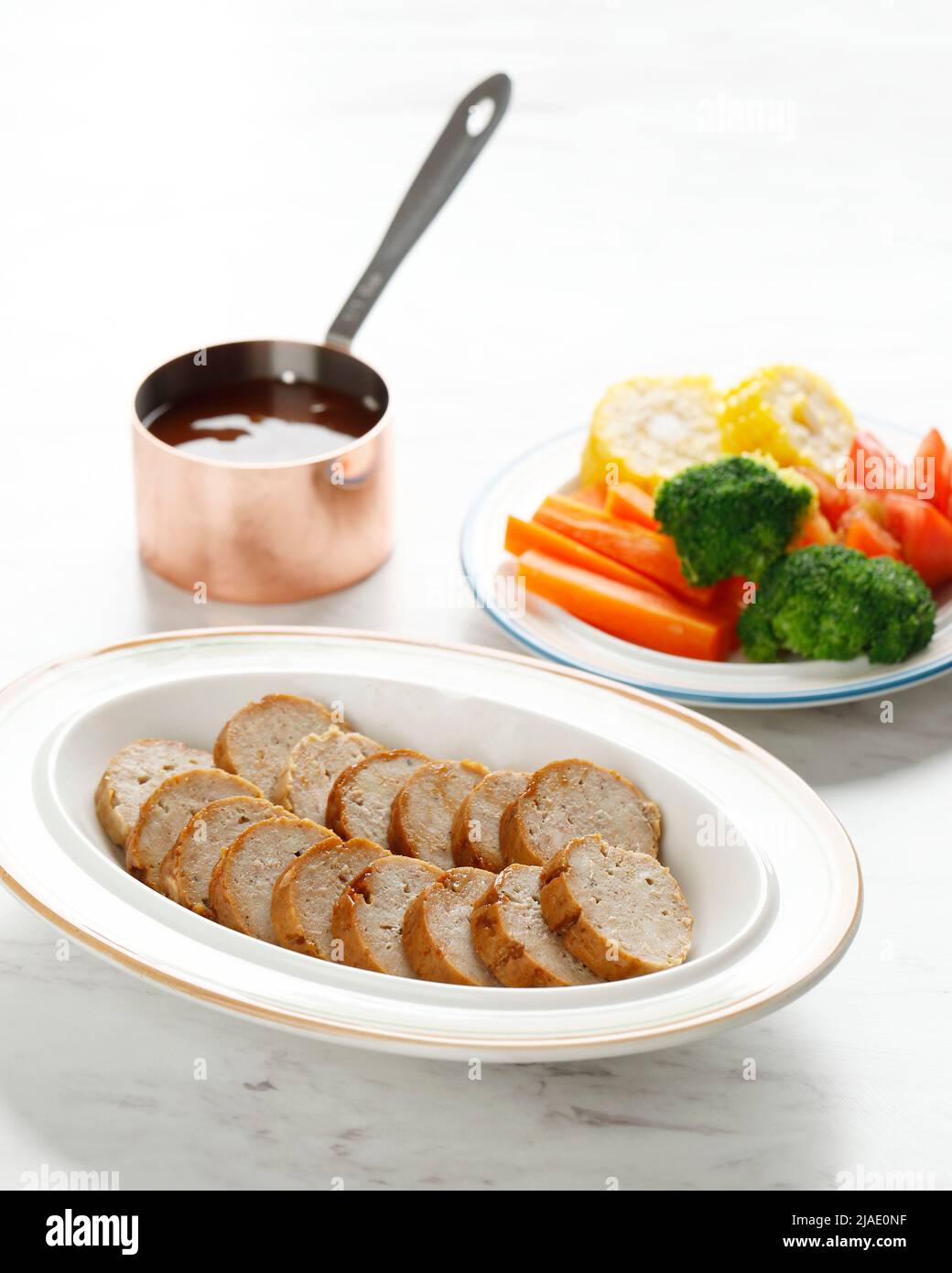 Chicken Galantine, Sliced, Served on White pPate with Bbq Sauce and Vegetables. Copy Space Stock Photo