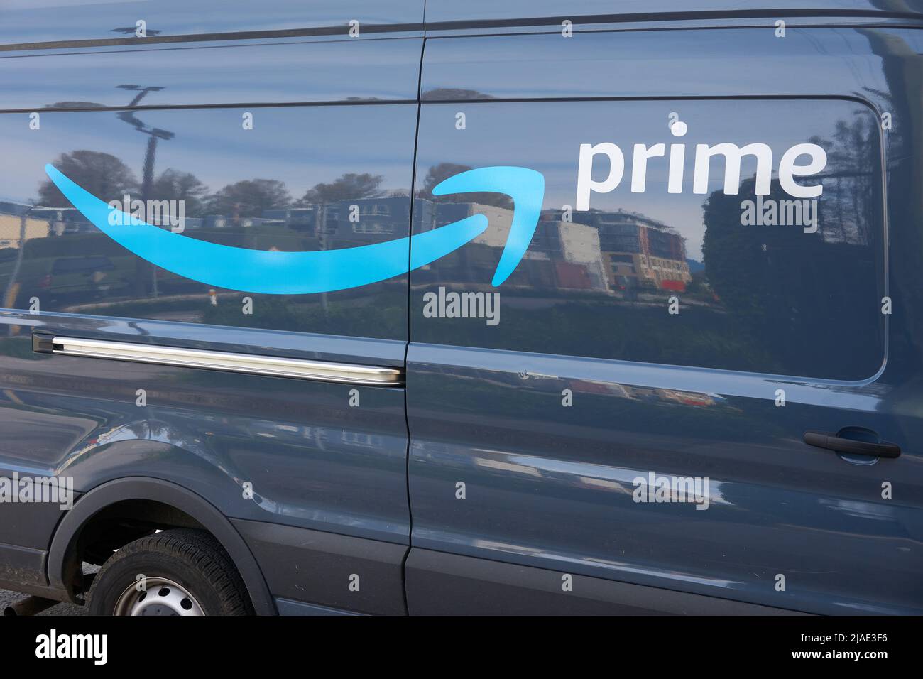 Closeup of the Amazon Prime arrow logo on the side of an Amazon delivery van Stock Photo