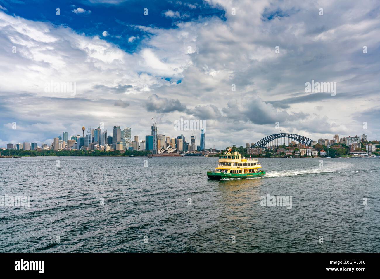 Sydney, Australia - Mar 25, 2022: View of Sydney skyline with ferry passing by Stock Photo