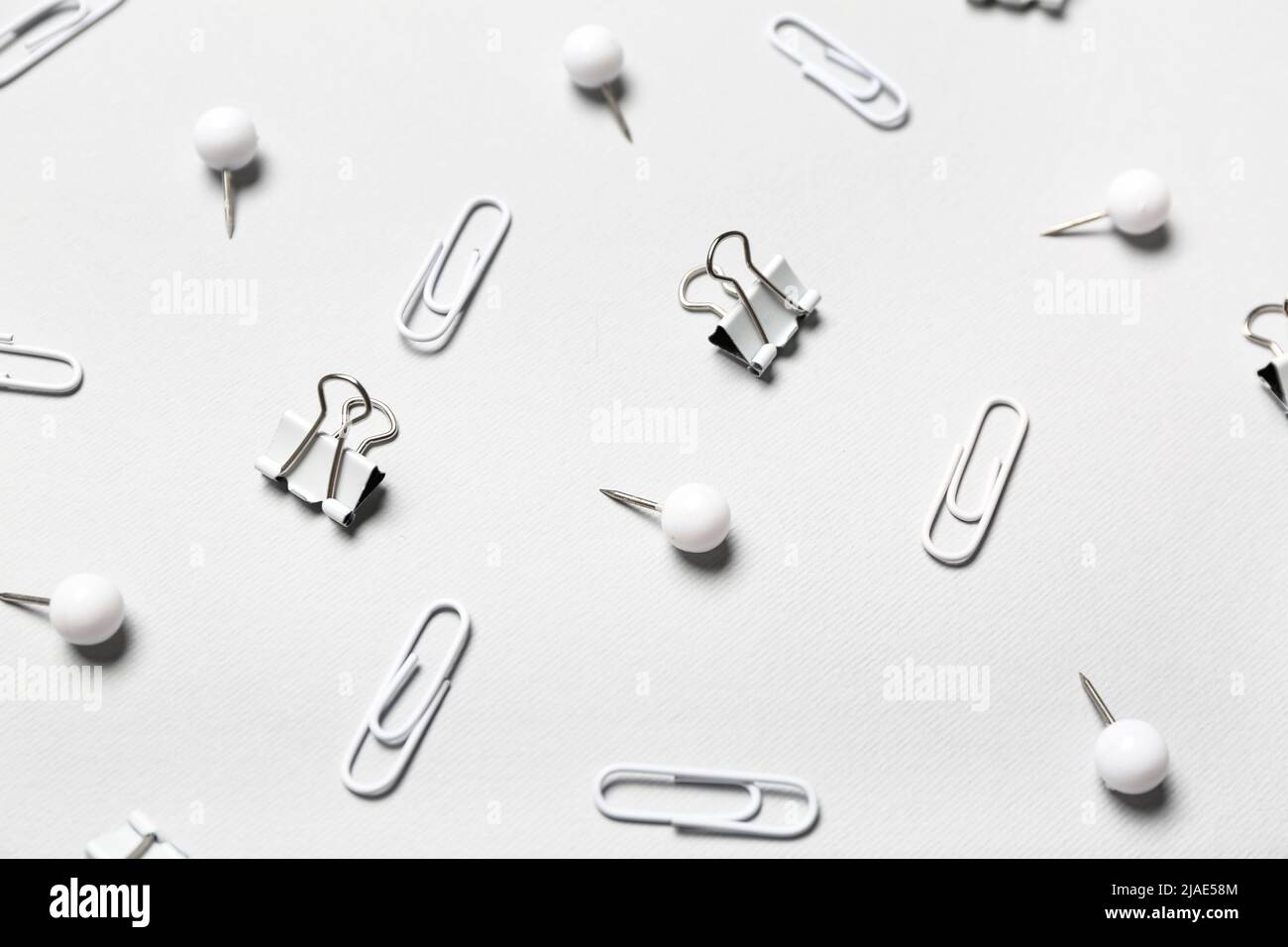 Different paper clips and pins on light background Stock Photo Alamy