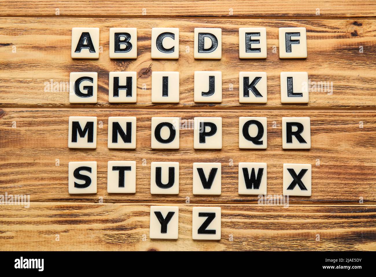 Different letters on wooden background. Alphabet concept Stock Photo
