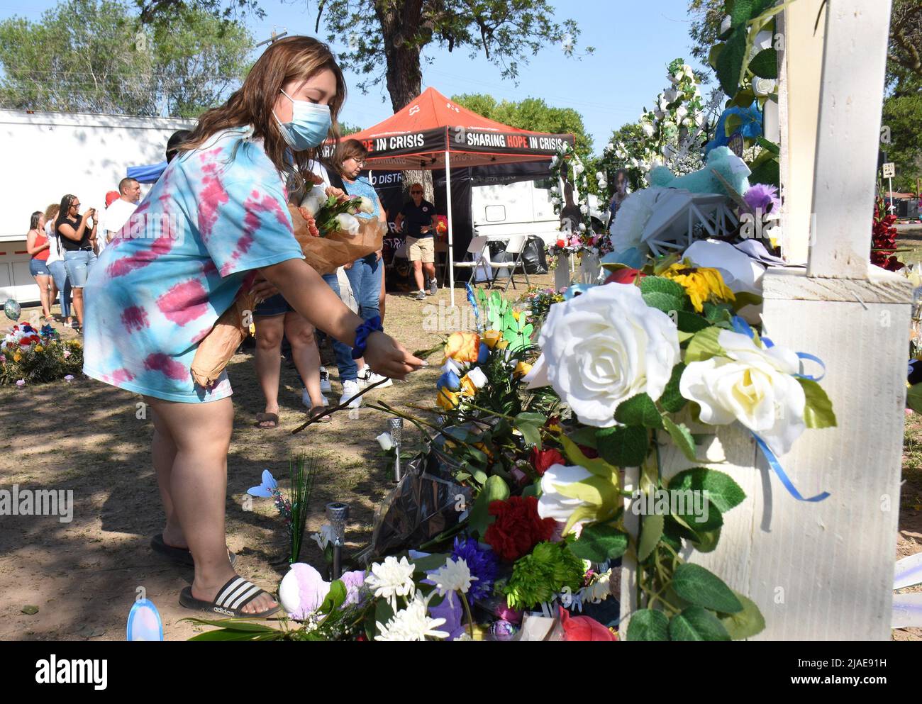 Uvalde, United States. 30th May, 2022. Mourners gather at a memorial of flowers at Robb Elementary School in Uvalde, Texas on Sunday, May 29, 2022. A mass shooting days before left 19 children and two adults dead at the elementary school. Photo by Jon Farina/UPI Credit: UPI/Alamy Live News Stock Photo