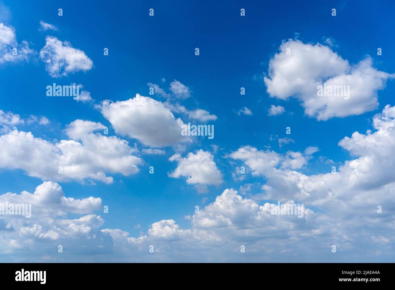 Blue sky background with many cumulus clouds Stock Photo