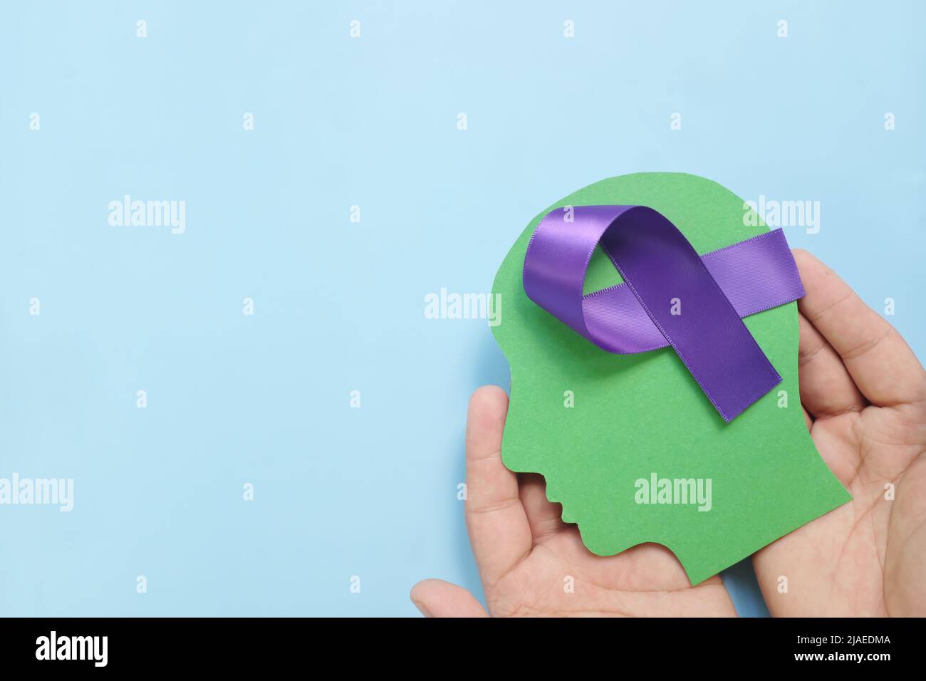 Purple Adhd Ribbon Hand holding human head profile with purple awareness ribbon on brain ...