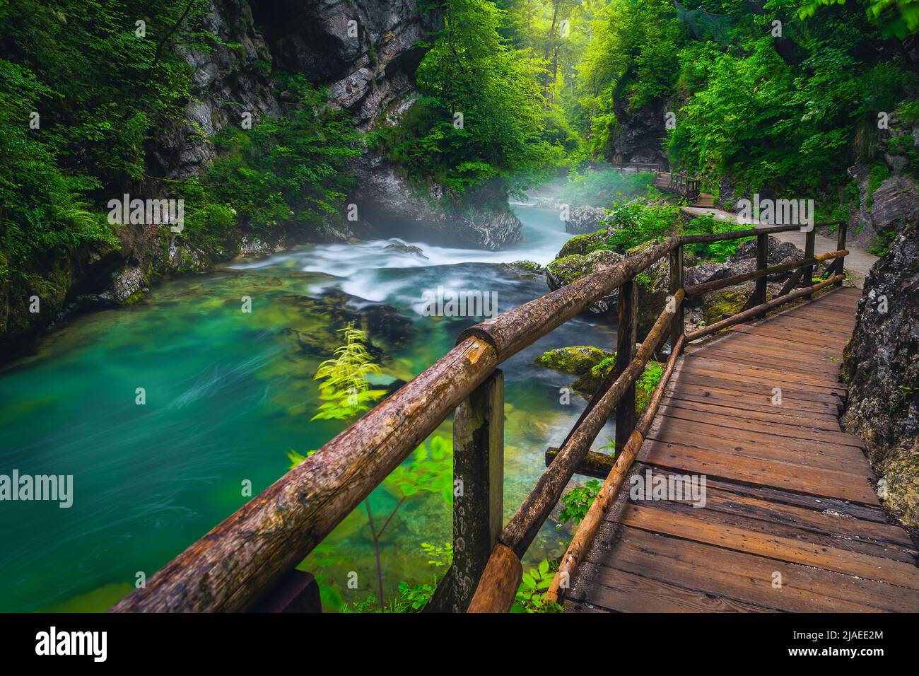 Touristic wooden footbridge in the misty Vintgar gorge. Admirable scenery with clean mountain river in the deep gorge, Bled, Slovenia, Europe Stock Photo