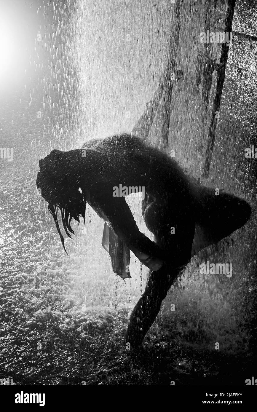 Girl dancing in the waterfall Stock Photo