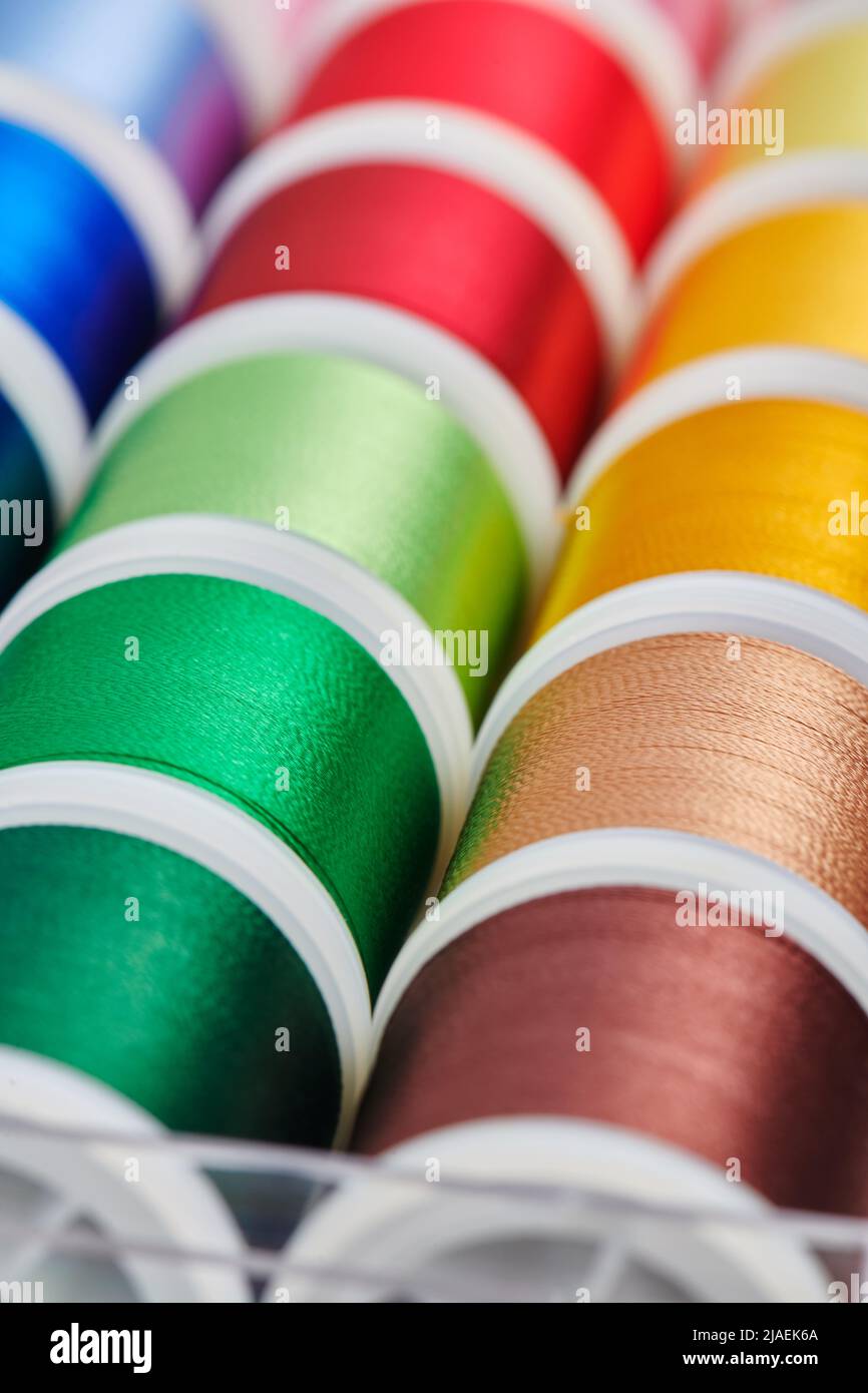 Background of spools with multicolored sewing threads Stock Photo