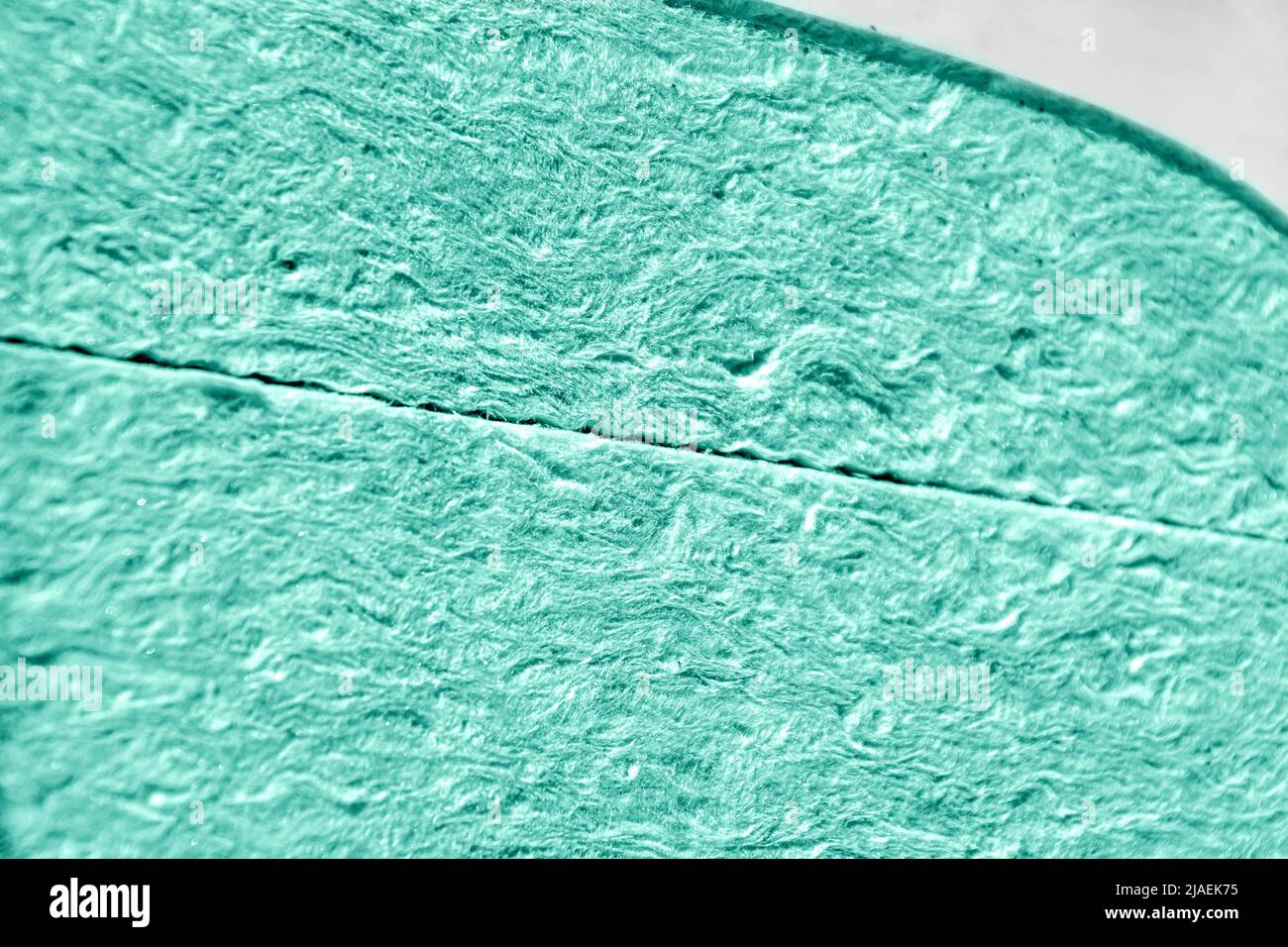 mineral wool or glass wool in blue-green color in a package, selective focus Stock Photo
