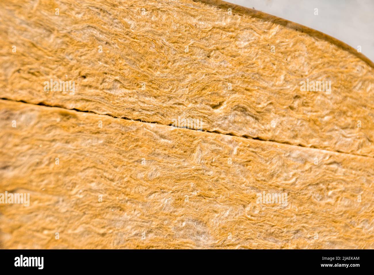 mineral wool or glass wool of red-yellow or orange color in packaging, selective focus Stock Photo
