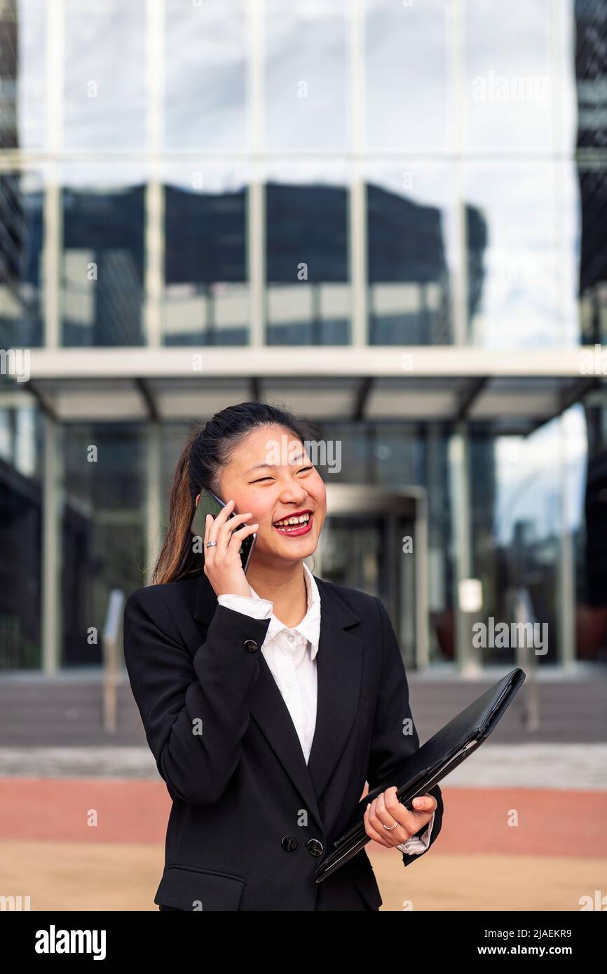 asiatic business woman talking by phone outdoors Stock Photo