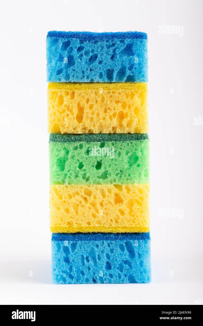 Colored sponges for washing dishes and other domestic needs on a white background. Stock Photo