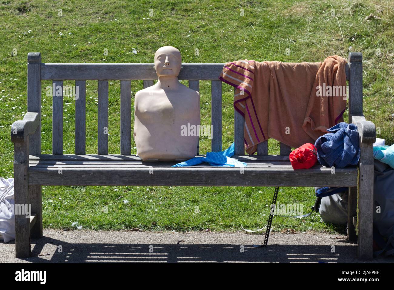 life saving dummy sitting on a bench. Stock Photo