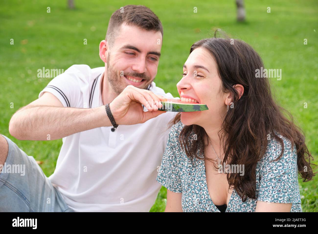 Happy young man giving watermelon to his girlfriend. Stock Photo