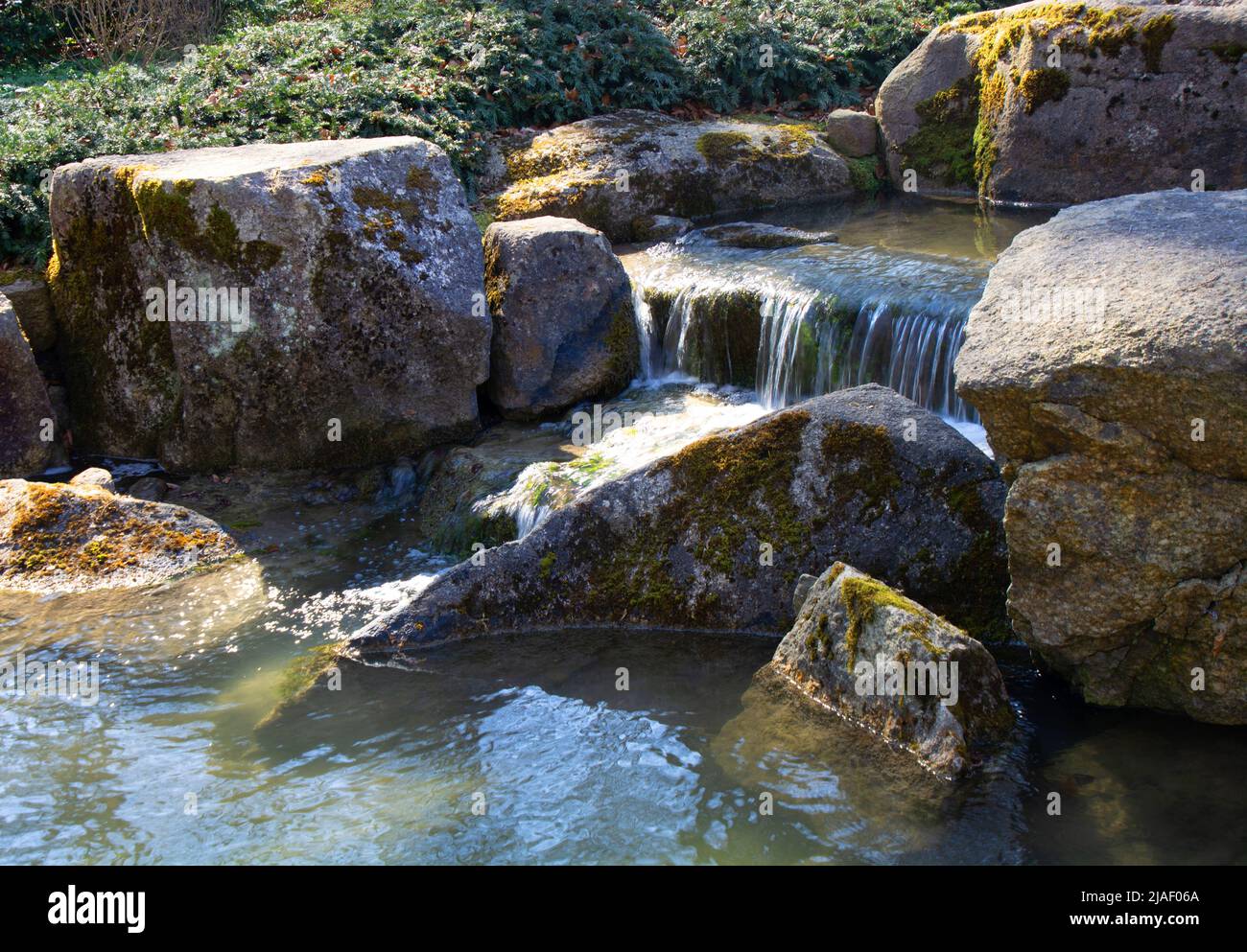 zen garden with a small stream and bubbling little waterfalls Stock Photo
