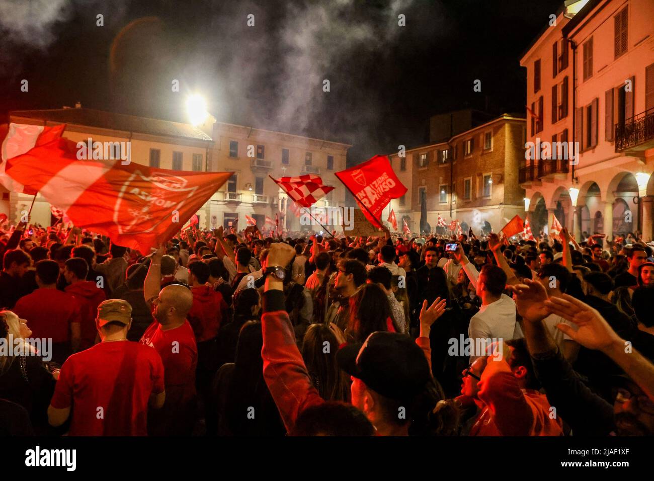 Monza fans celebrate the first historic promotion of Monza Calcio to Serie A in its 110-year history in Monza, Italy, on May 29 2022Monza fans celebrating in front of the big screen at U-Power Stadium during the Pisa v Monza match in Monza, Italy, on May 29 2022 Stock Photo