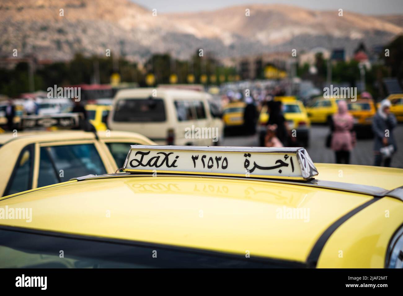 Damascus, Syria - May, 2022: Taxi sign closeup on Taxi car in street traffic of Damascus Stock Photo