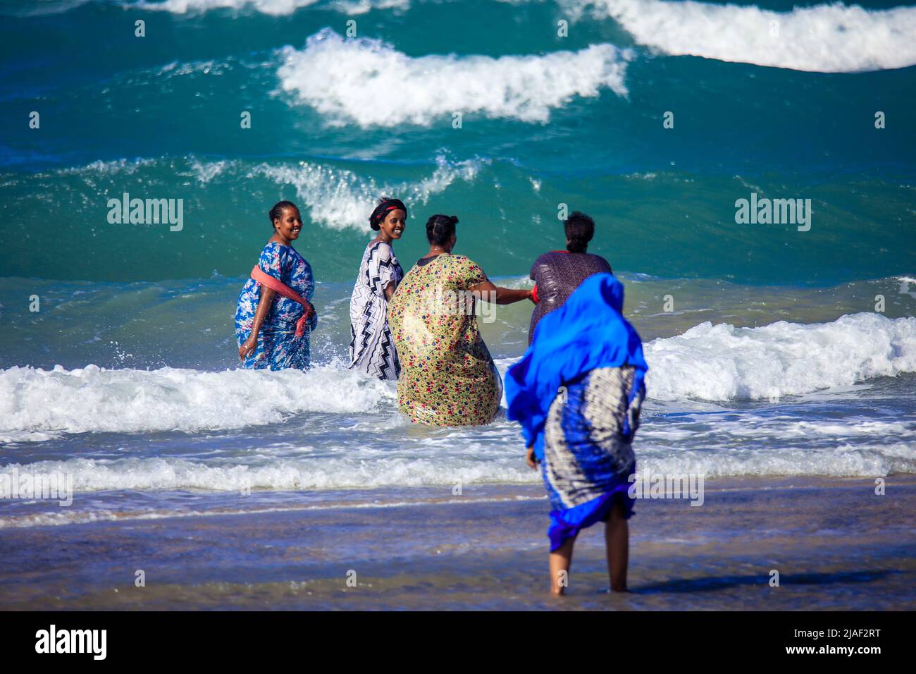 Local People Swimming in the Warm Water on the Sunny Day on the Berbera Coastline Stock Photo