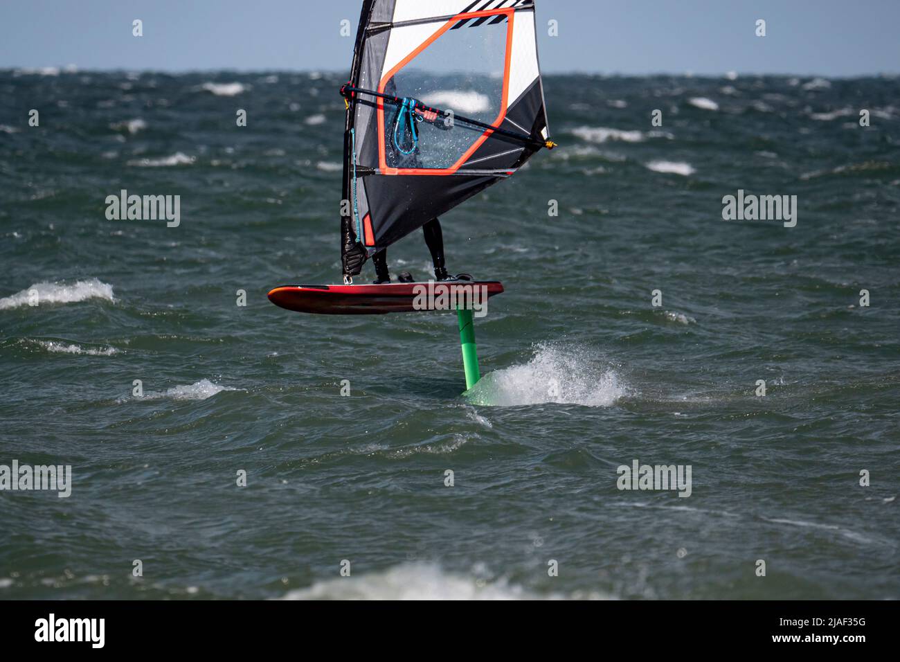 Wind Foil Surfer surf in the sea Stock Photo