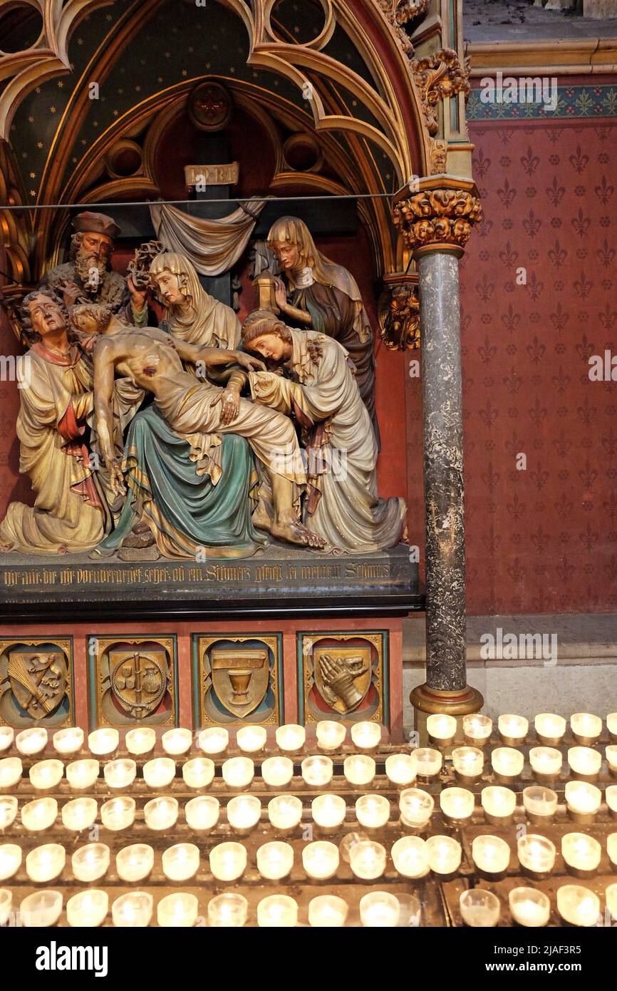 Praying candles and The 13th Station of The Cross inside of The Cologne Cathedral- Koln, Germany Stock Photo