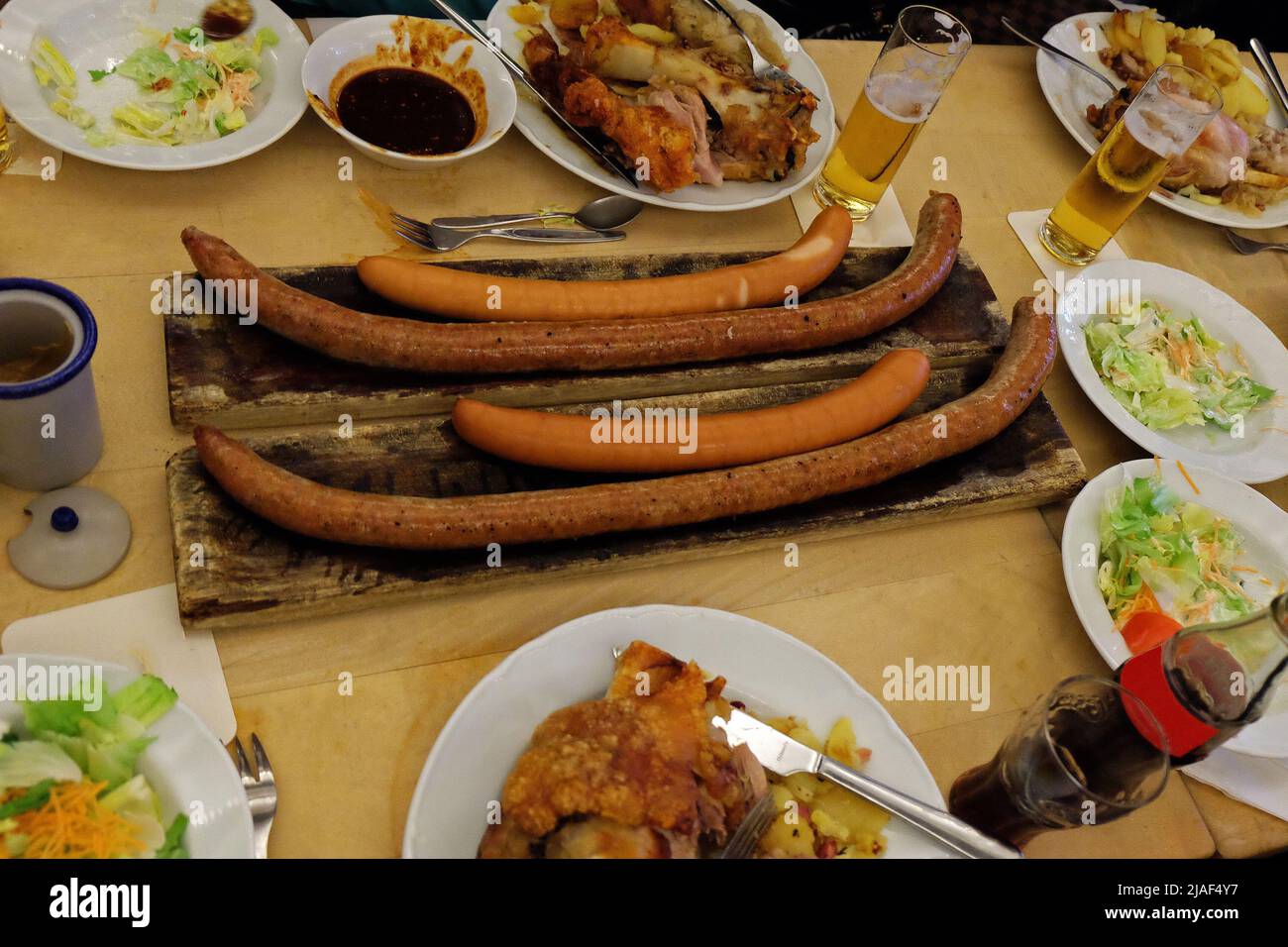 Close up German sausages and deep fried pork knuckle legs served with
