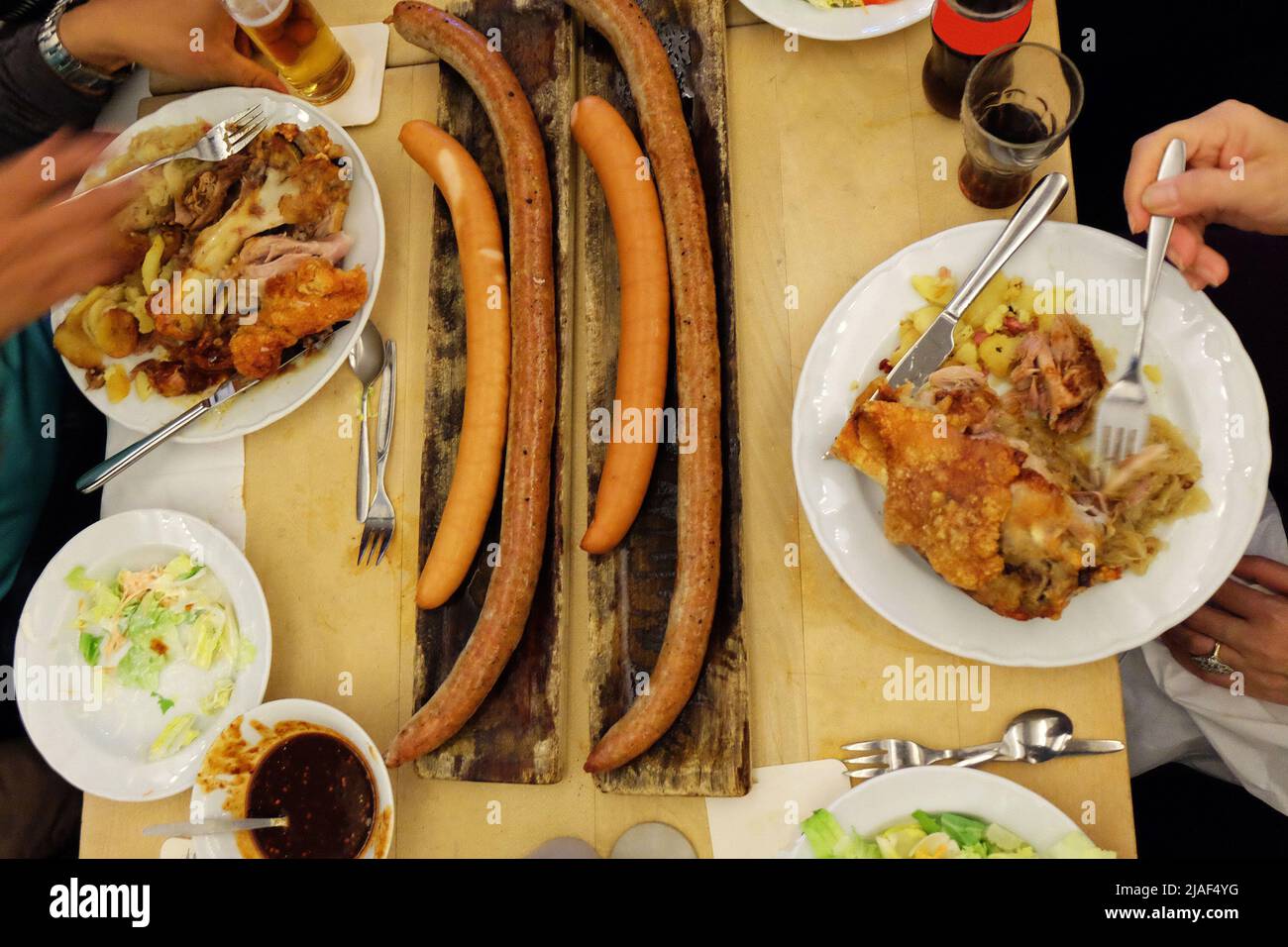 Close up German sausages and deep fried pork knuckle legs served with