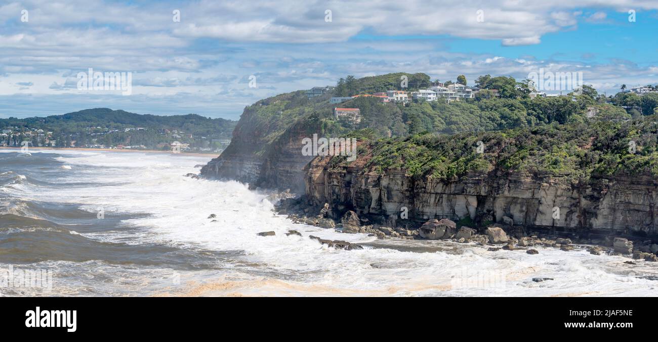 April 4th 2020, Terrigal, NSW, Australia: Seaspray blows up over the headland between Terrigal and North Avoca as wild seas batter the coastline Stock Photo