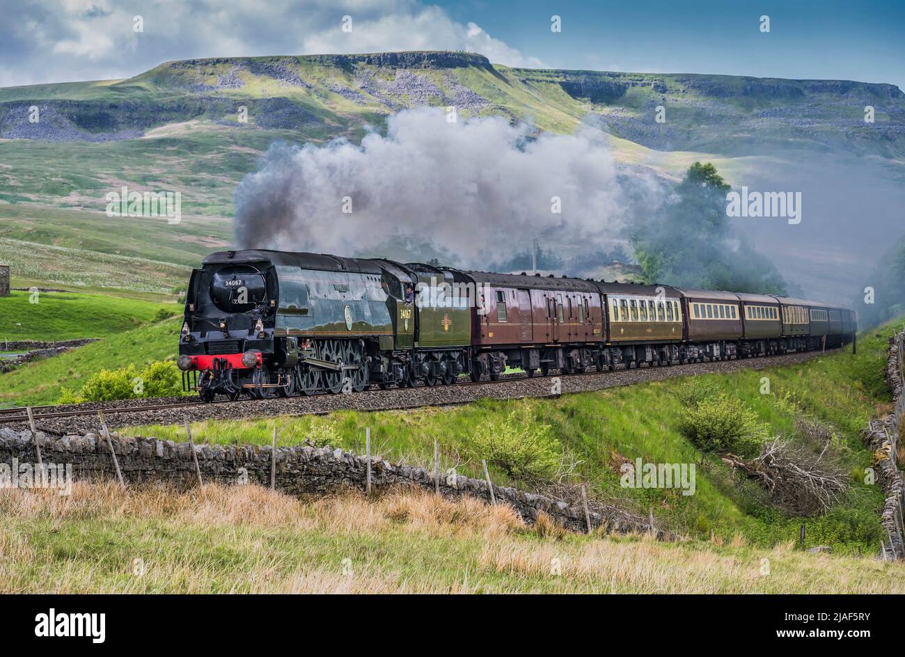 The image is of the Southern Railways Battle of Britain Class 4-6-2 #34067 Tangmere after passing through Ais Gill summit en-route to Garsdale station Stock Photo