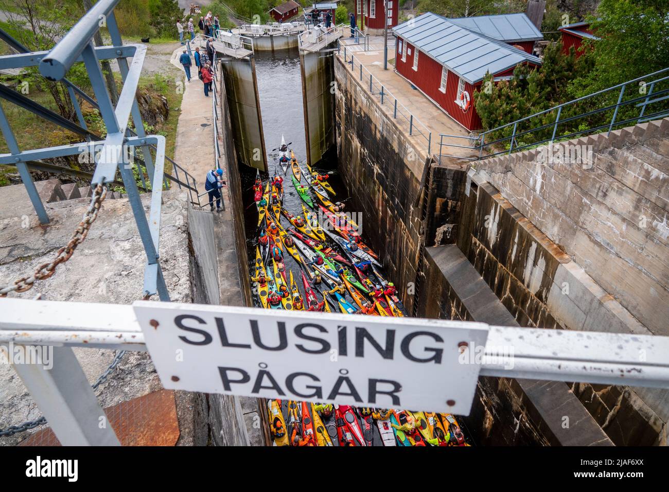 Brekke 20220529.60 colorful kayaks paddling through the locks of the Halden Canal on Sunday. With its 26.6 m total lifting height in four chambers, Brekke locks are Northern Europe's highest continuous lock staircase. After a two-year pandemic break, there is a record-breaking participation in the annual 57 km long paddle trip from Oerje to Halden. Photo: Heiko Junge / NTB Stock Photo
