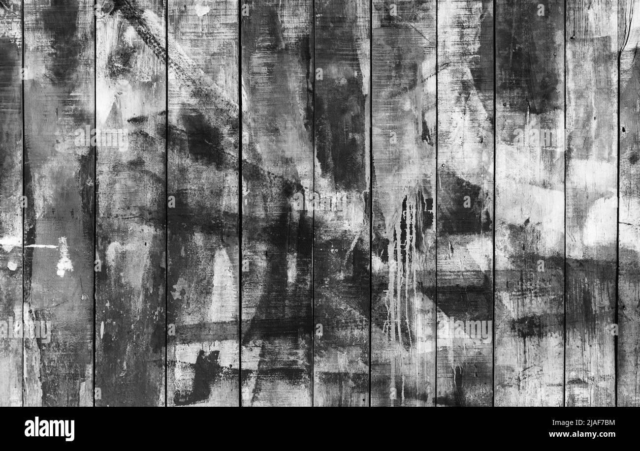 Grungy old wooden wall with black paint strokes, abstract background photo texture Stock Photo