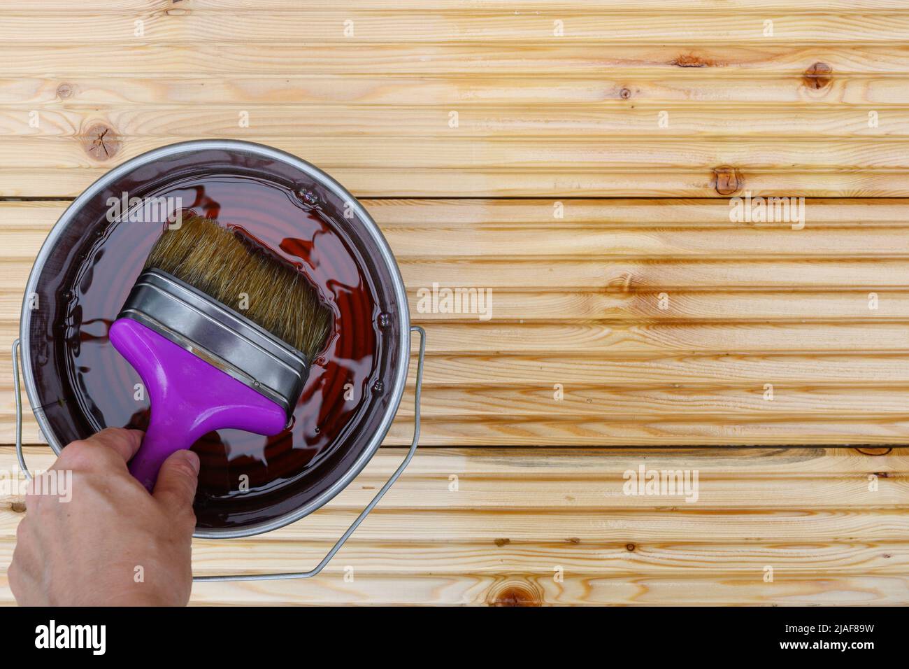 Painting new wooden boards for patio by special waterproof protective