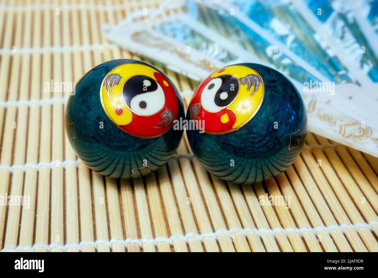 Chinese meditation balls and a fan. Baoding balls with yinyang symbol
