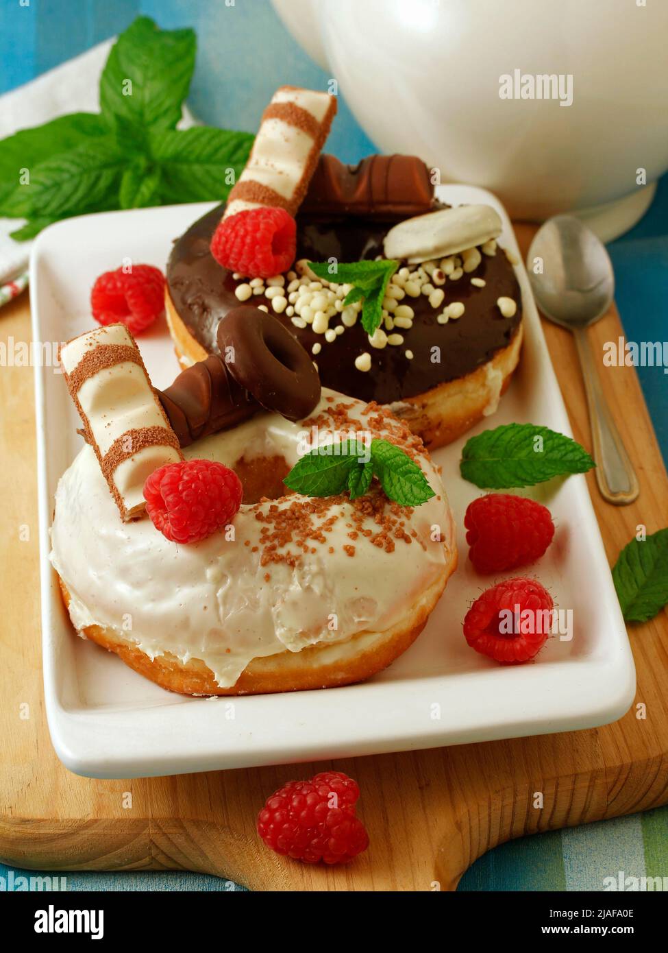 Big donuts with chocolate and rasberries. Stock Photo