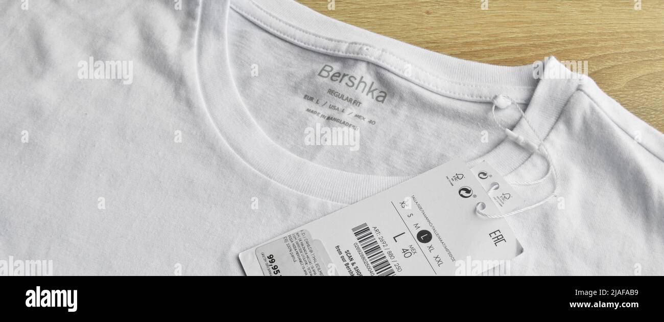 New white Bershka L t-shirt and blank label, on wooden floor ...