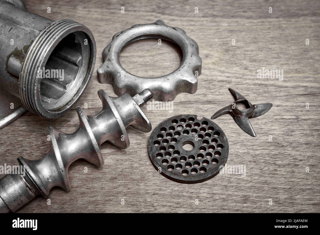 Old manual meat grinder unassembled on a table Stock Photo Alamy