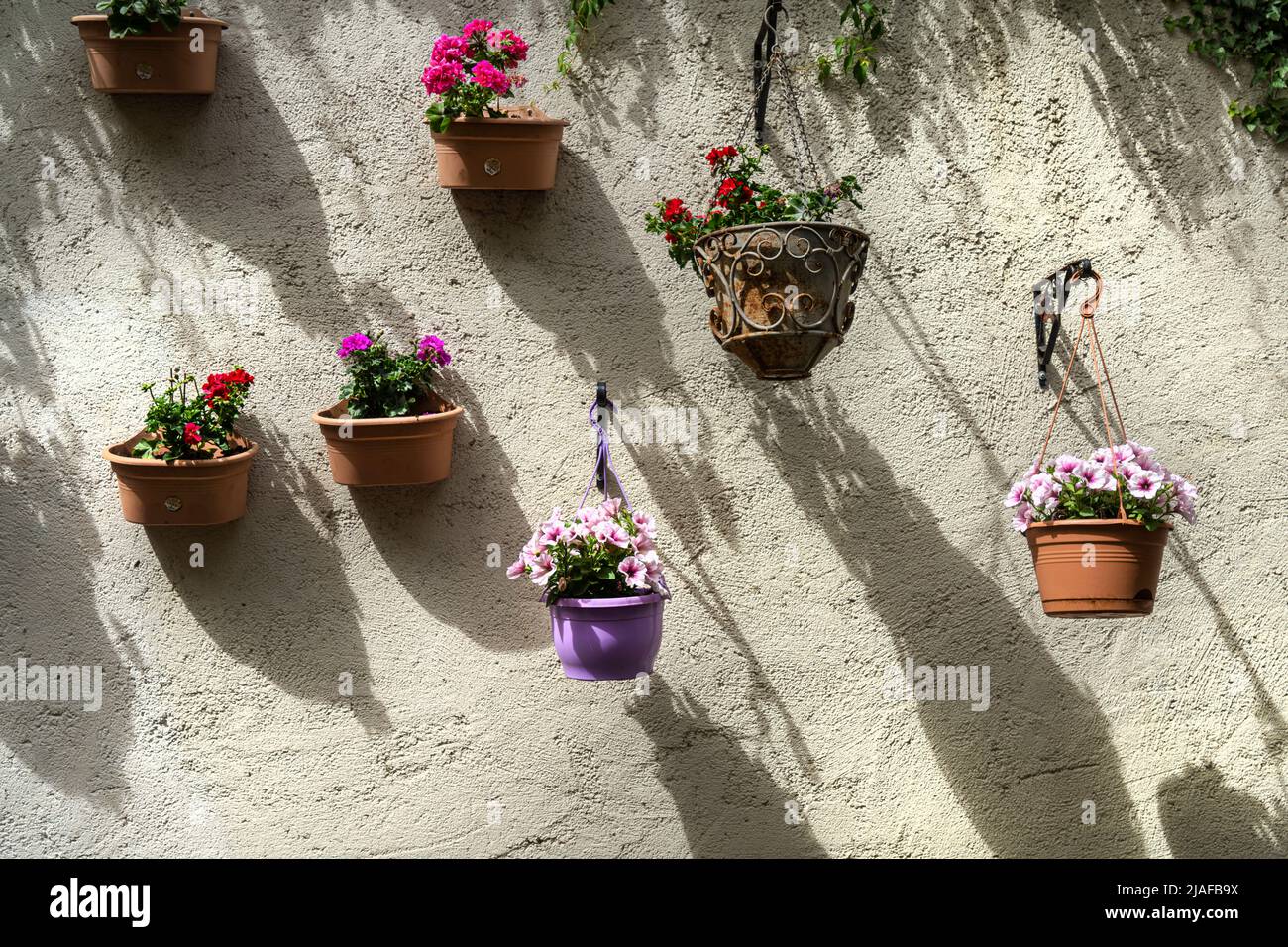 Luxembourg city, May 2022.  flower pots hanging on the wall Stock Photo