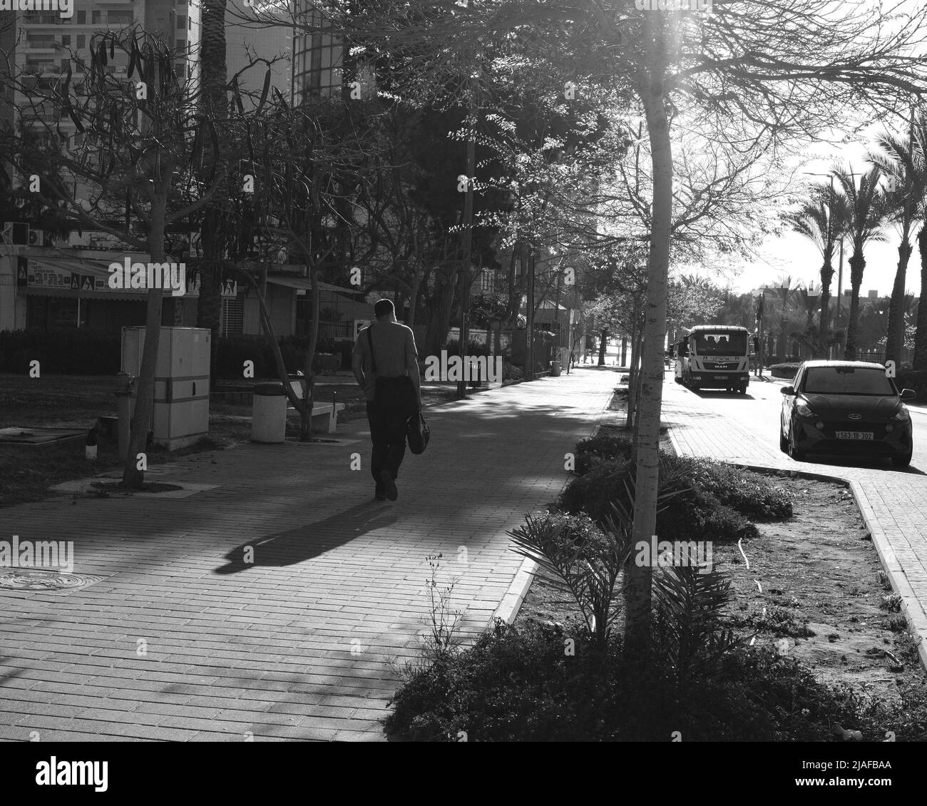 Shadow man walking in street hi-res stock photography and images - Alamy