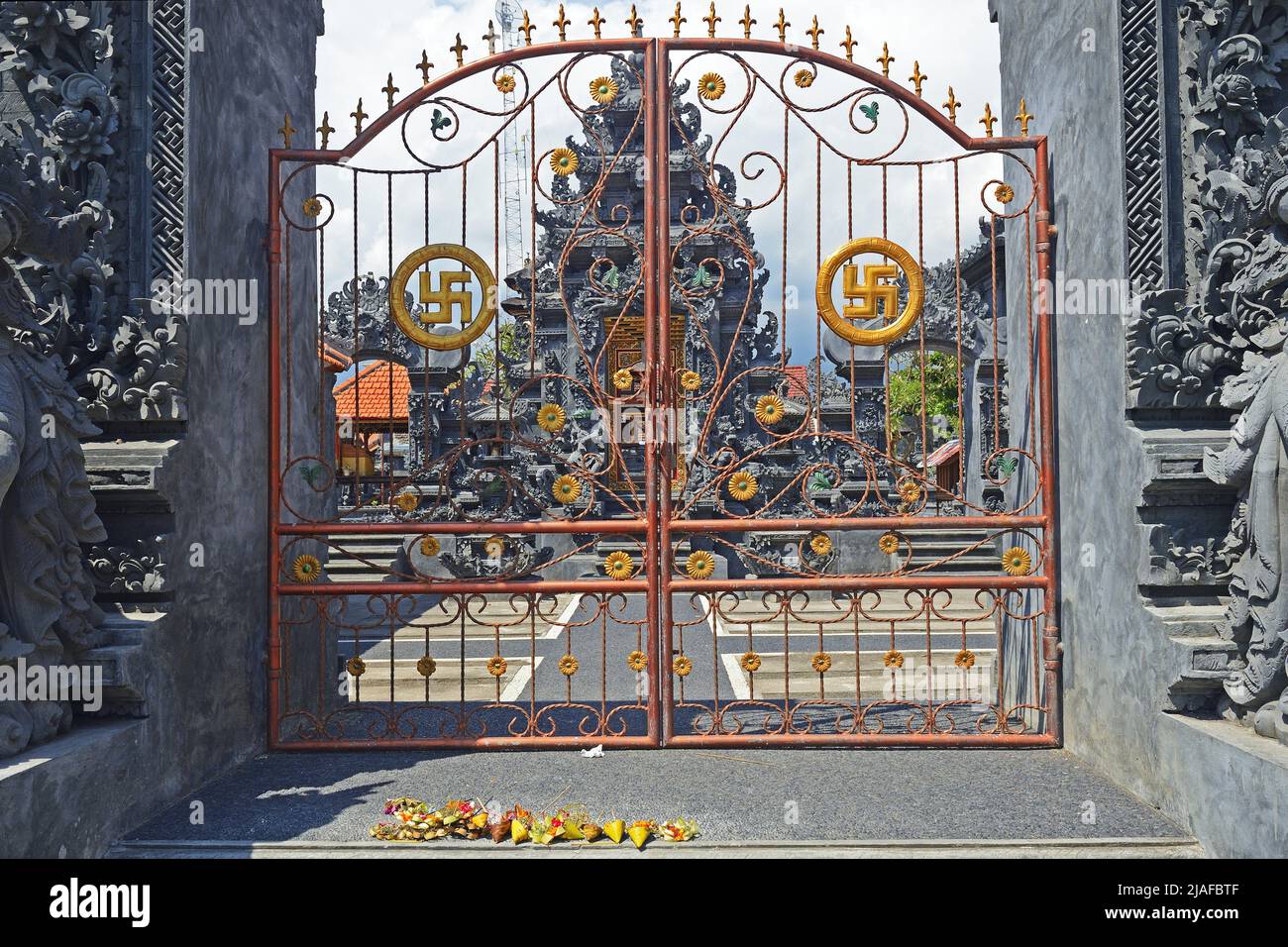 Swastika-festooned Gate,  lucky symbol in Hinduism, at the temple Pura Segara, Lovina Beach, Indonesia, Bali Stock Photo
