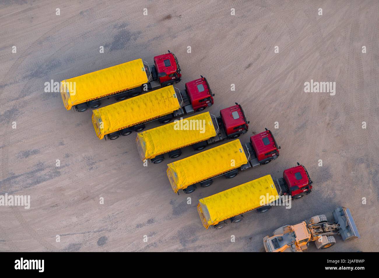 Parked lorries and excavator, 05/27/2022, aerial view, Germany, Schleswig-Holstein Stock Photo